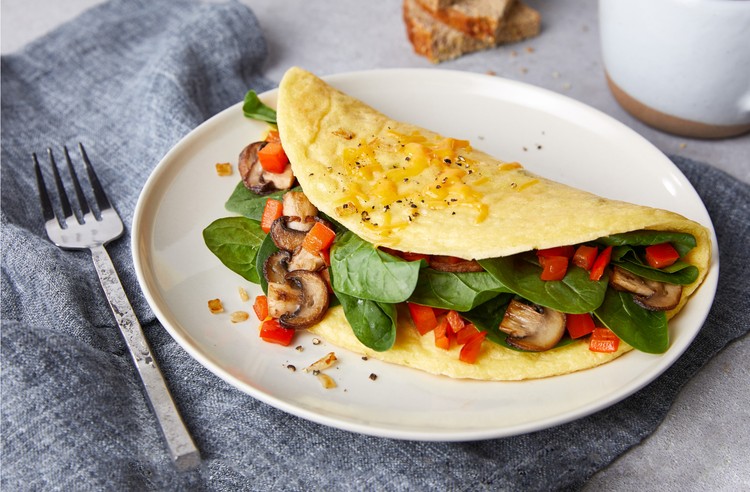 JUST Egg omelet with mushroom, spinach, and tomatoes on a plate