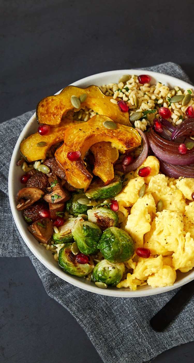 A bowl with JUST Egg, grains and roasted vegetables