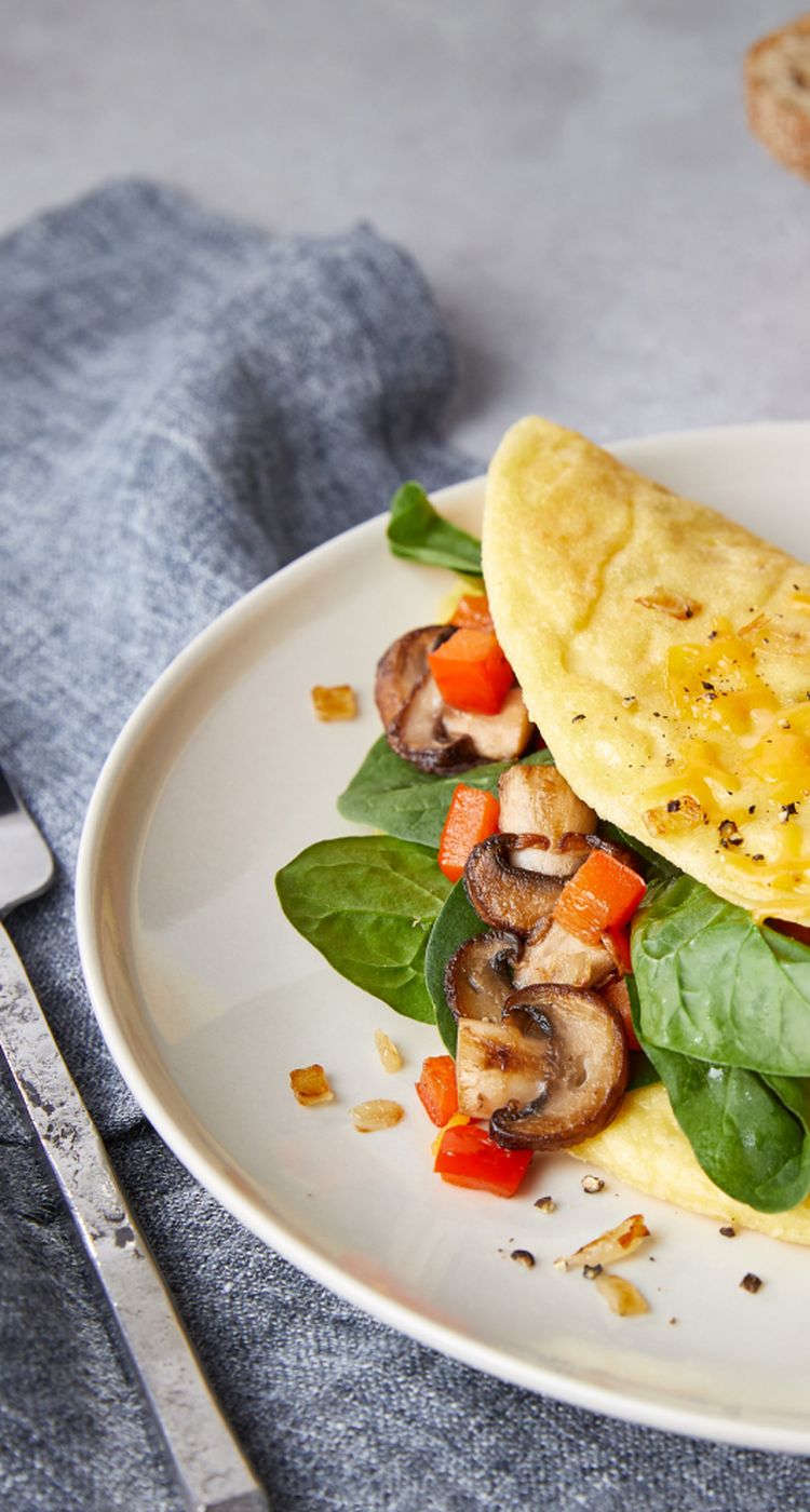 JUST Egg omelet with mushroom, spinach, and tomatoes on a plate