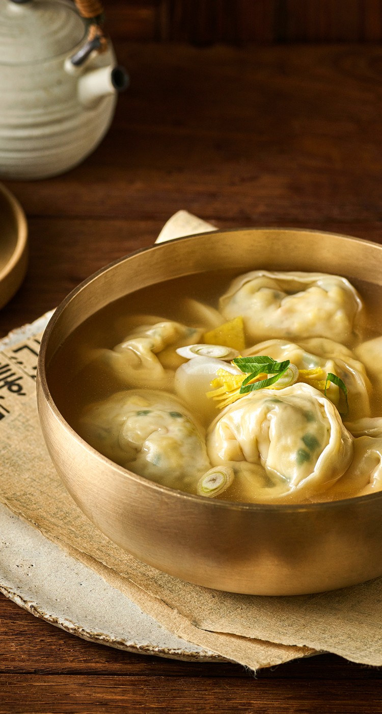 Vegan dumpling soup made with JUST Egg in a gold bowl