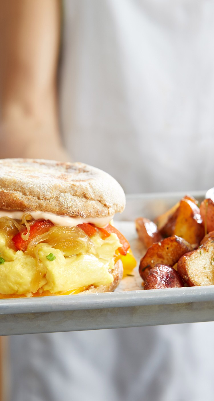 Egg sandwich with a side of potatoes